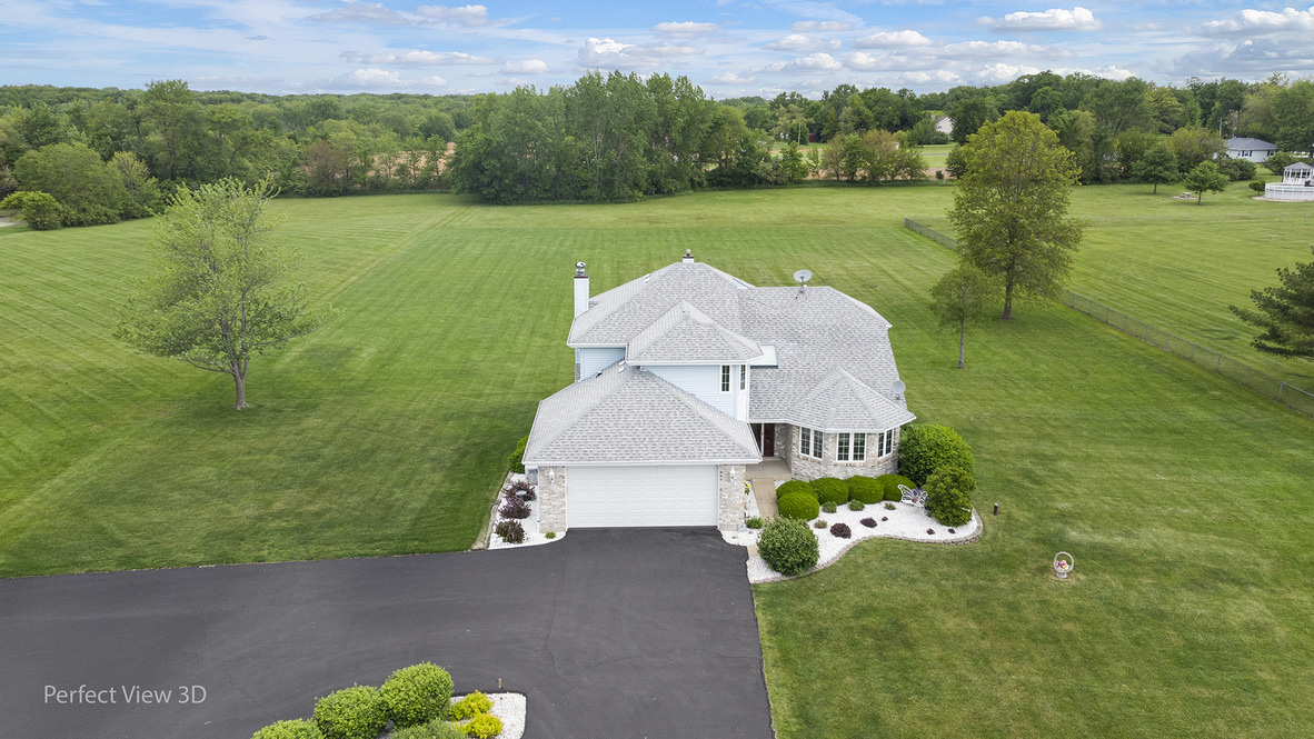 13836 West Joliet Road Manhattan, IL 60442 - Photo 3 of 25 a view of a house with a yard and a large pool