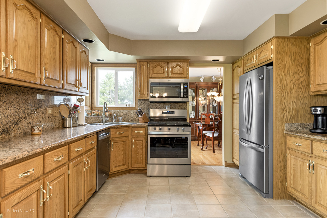 13836 West Joliet Road Manhattan, IL 60442 - Photo 6 of 25 a kitchen with stainless steel appliances granite countertop a refrigerator and a sink