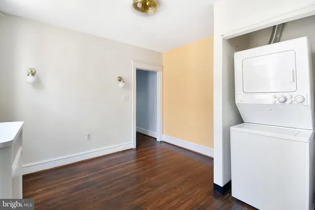 a view of washer and dryer with wooden floor