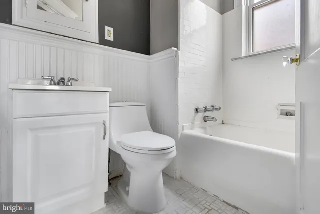 a bathroom with a sink a toilet and bathtub