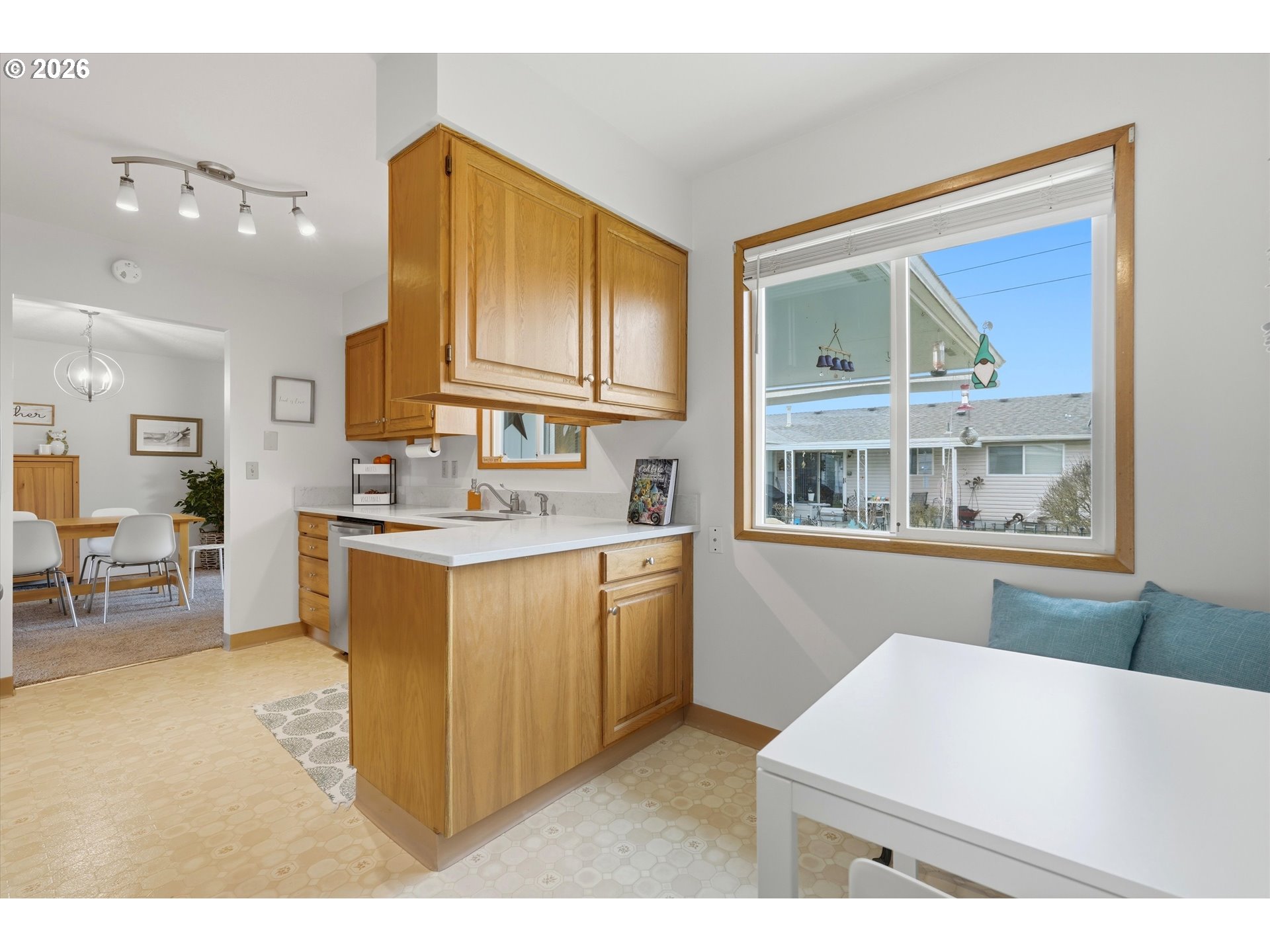 1841 Umpqua Road Woodburn, OR 97071 - Photo 20 of 41 a kitchen with kitchen island a sink a stove a refrigerator cabinets and a dining table