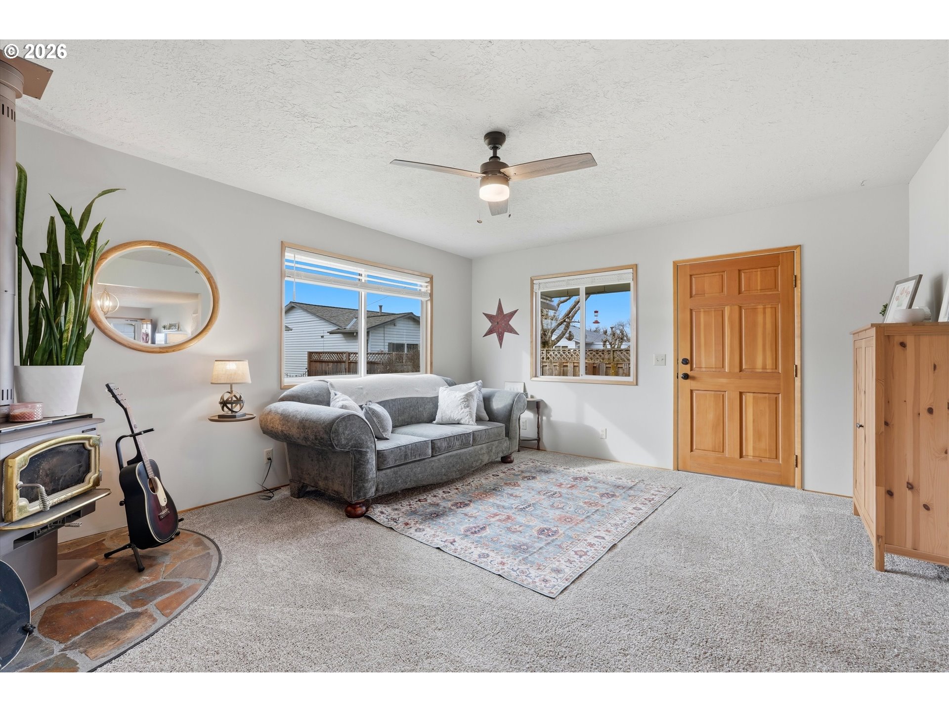 1841 Umpqua Road Woodburn, OR 97071 - Photo 23 of 41 a living room with furniture a window and a flat screen tv