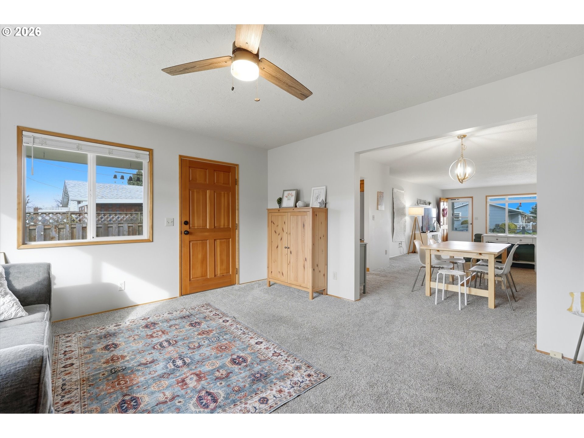 1841 Umpqua Road Woodburn, OR 97071 - Photo 26 of 41 a living room with furniture a chandelier and a dining table with wooden floor