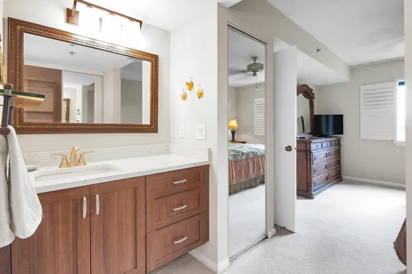 a bathroom with a sink a toilet and mirror