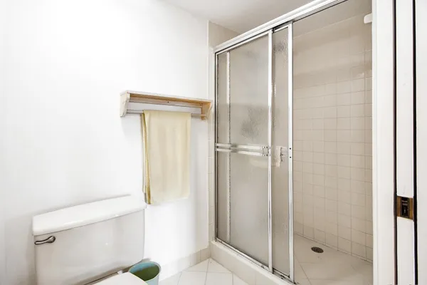 a bathroom with a glass shower door