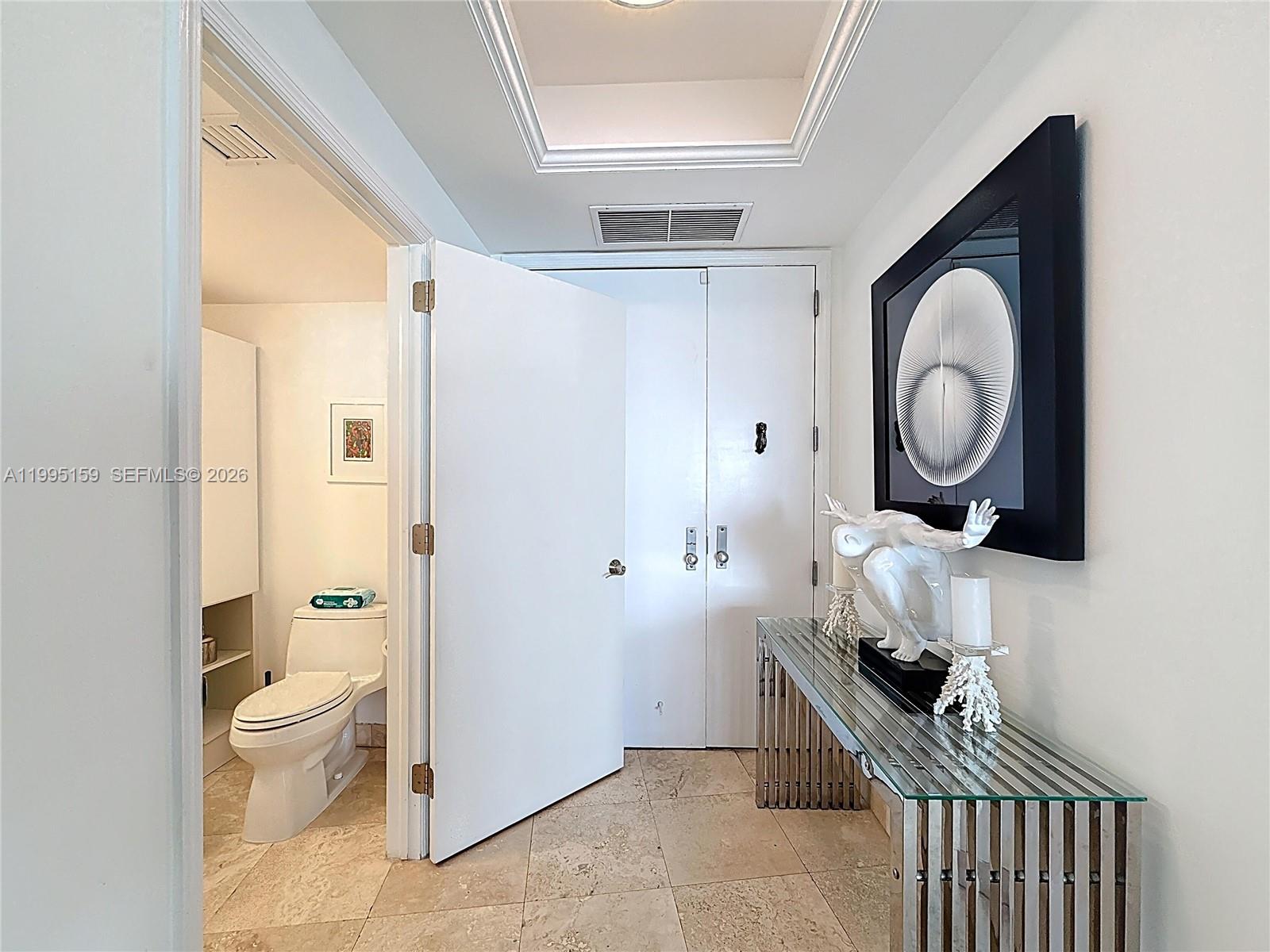 808 Brickell Key Drive, Unit 2002 Miami, FL 33131 - Photo 12 of 42 a living room with furniture and a toilet