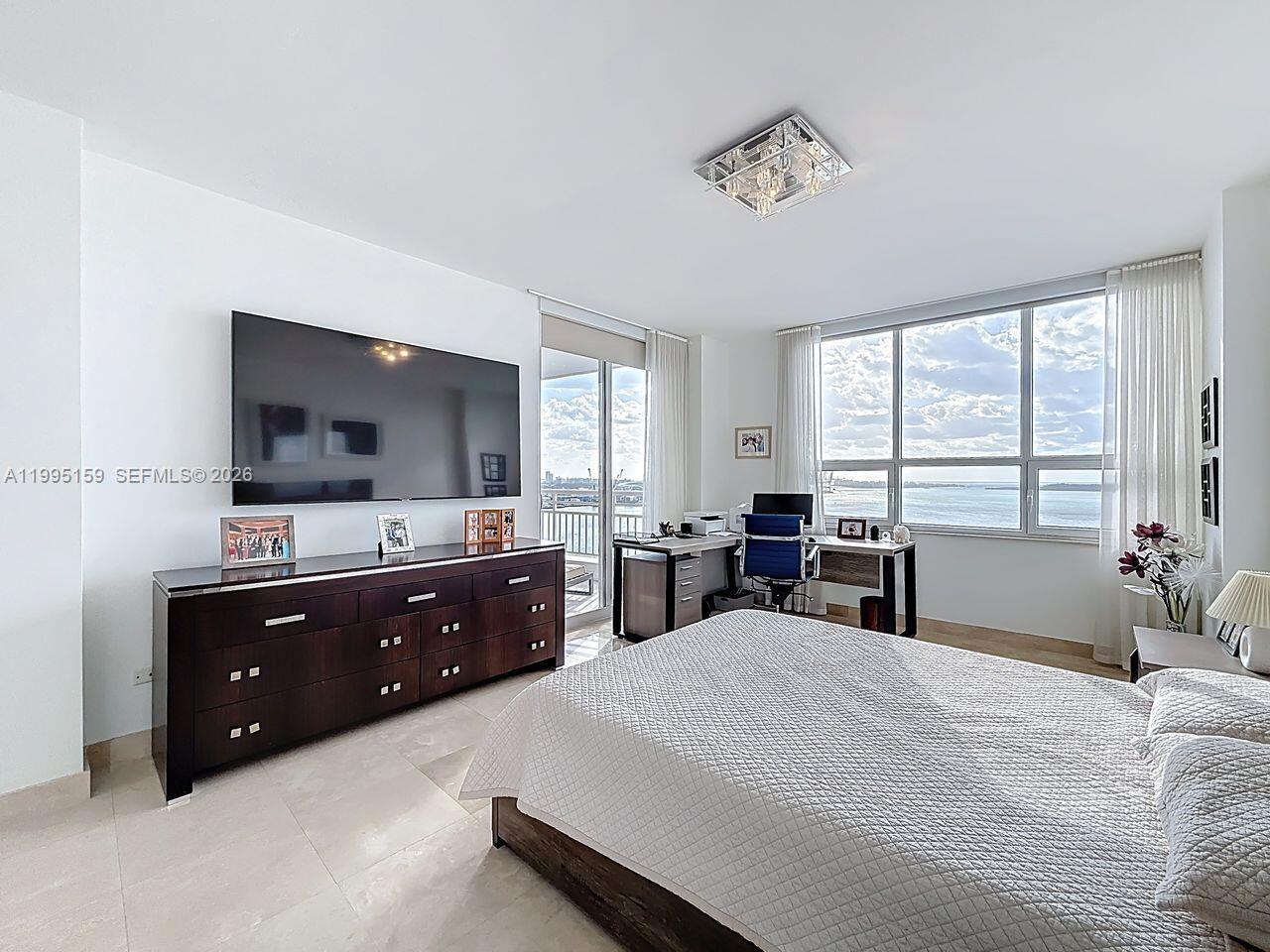 808 Brickell Key Drive, Unit 2002 Miami, FL 33131 - Photo 15 of 42 a bed room with a bed and a television