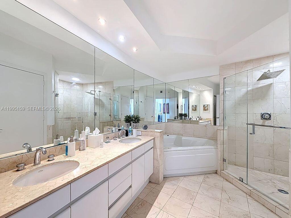 808 Brickell Key Drive, Unit 2002 Miami, FL 33131 - Photo 16 of 42 a bathroom with a granite countertop sink mirror and bathtub