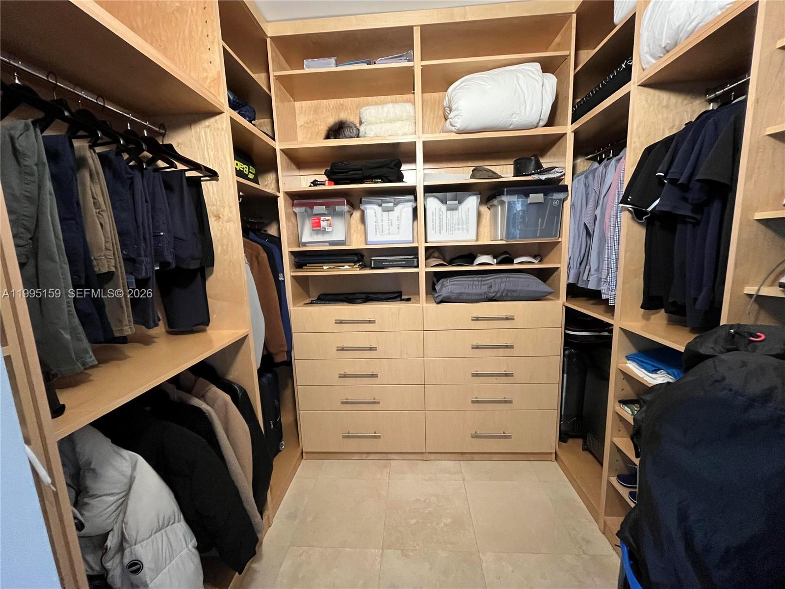 808 Brickell Key Drive, Unit 2002 Miami, FL 33131 - Photo 17 of 42 a view of walk in closet with clothes and shoes