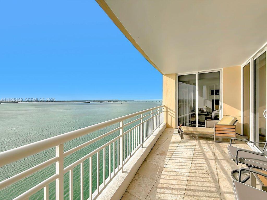 808 Brickell Key Drive, Unit 2002 Miami, FL 33131 - Photo 25 of 42 a view of balcony with couch and wooden floor