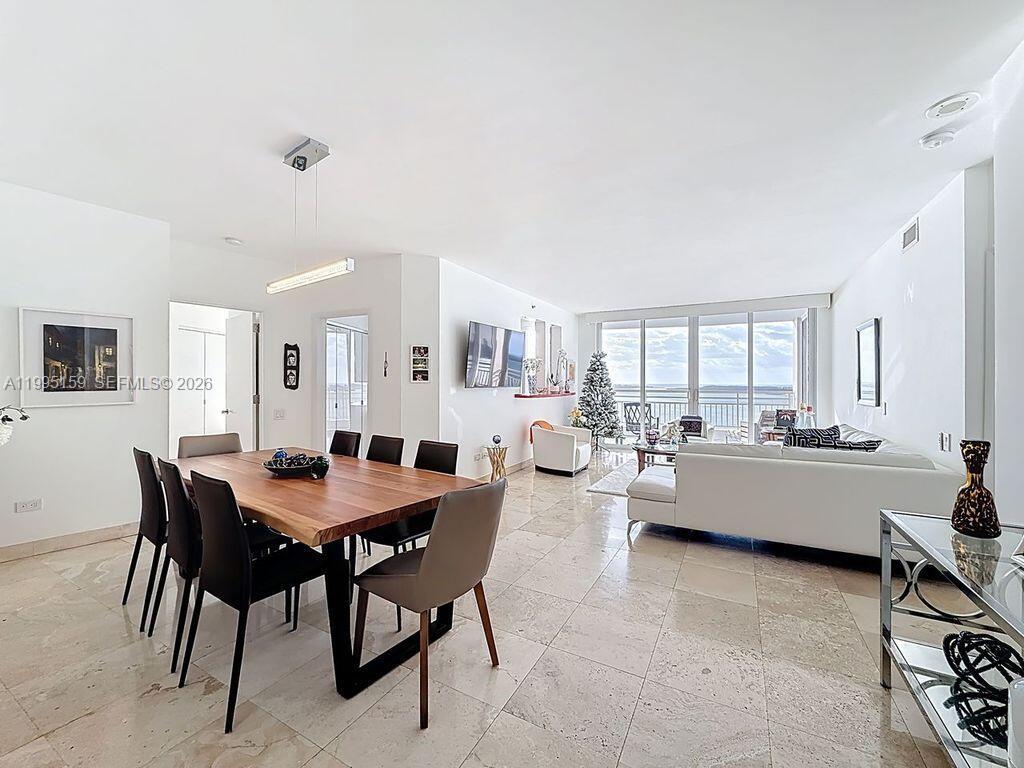 808 Brickell Key Drive, Unit 2002 Miami, FL 33131 - Photo 3 of 42 a large dining room with a table and chairs in it