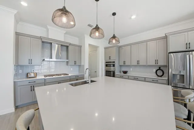 a living room with furniture and a view of kitchen