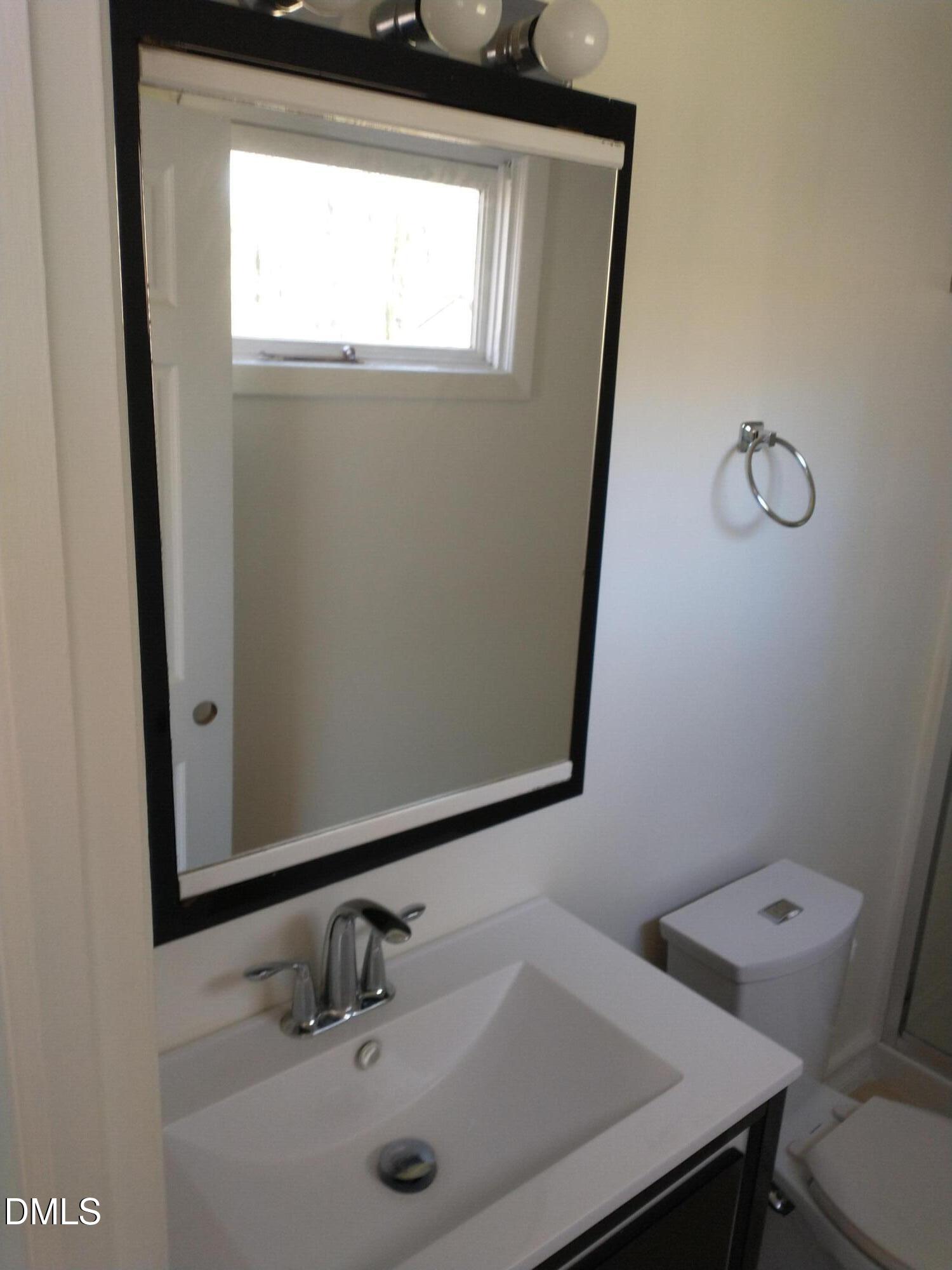 1302 Lorimer Road Raleigh, NC 27606 - Photo 12 of 23 a bathroom with a sink and a toilet