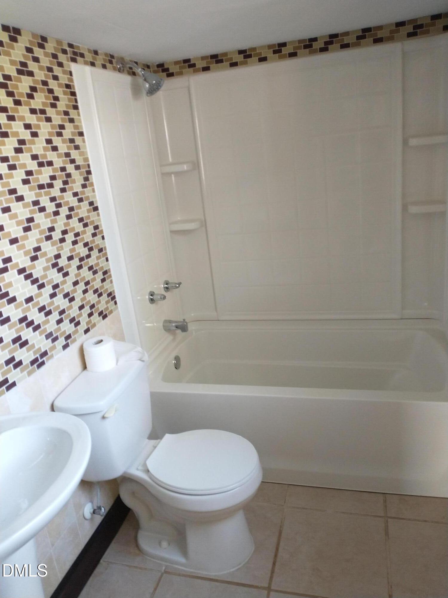 1302 Lorimer Road Raleigh, NC 27606 - Photo 14 of 23 a bathroom with a toilet and a shower