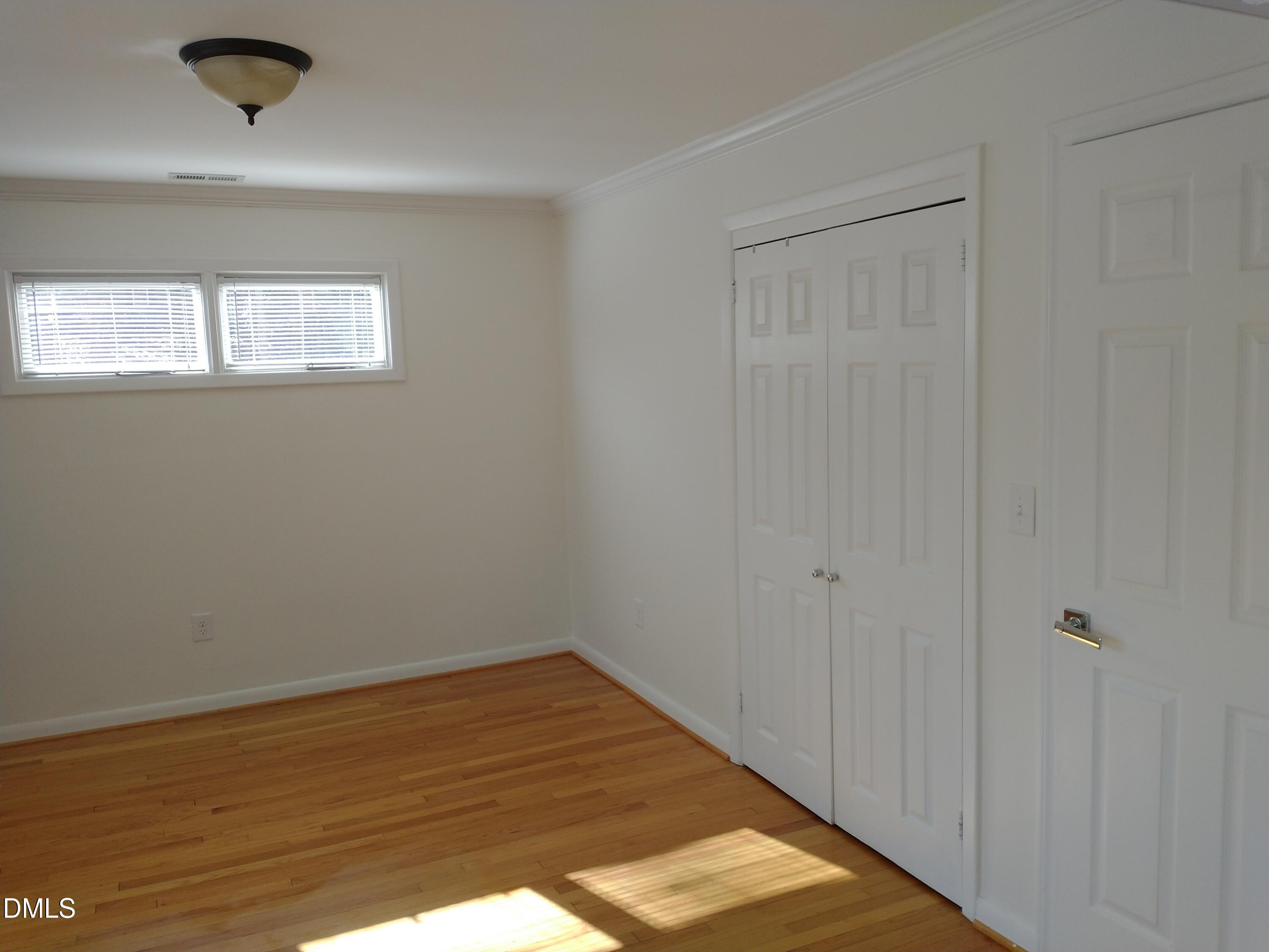 1302 Lorimer Road Raleigh, NC 27606 - Photo 15 of 23 a view of a hallway with wooden floor
