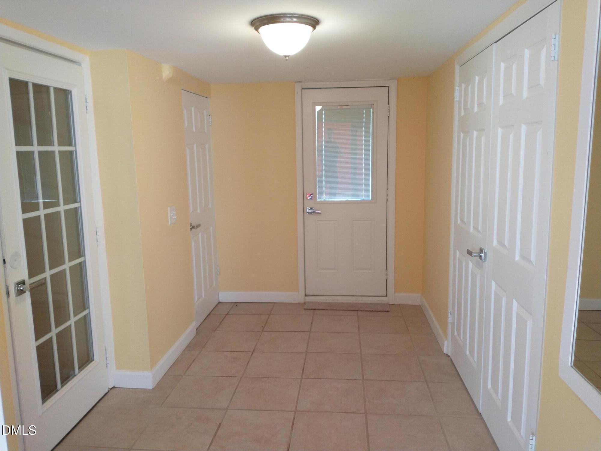 1302 Lorimer Road Raleigh, NC 27606 - Photo 17 of 23 a view of hallway with walk in closet with wooden floor