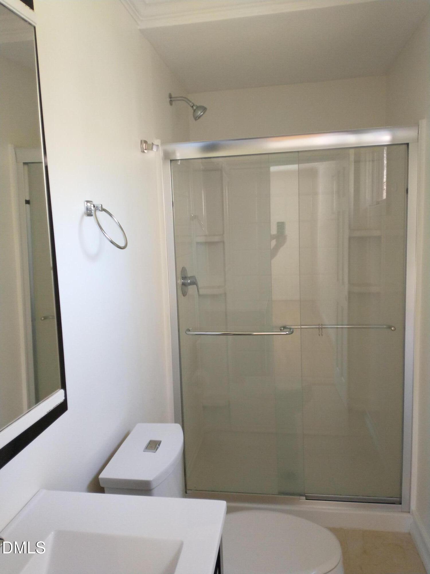 1302 Lorimer Road Raleigh, NC 27606 - Photo 18 of 23 a bathroom with a toilet and shower