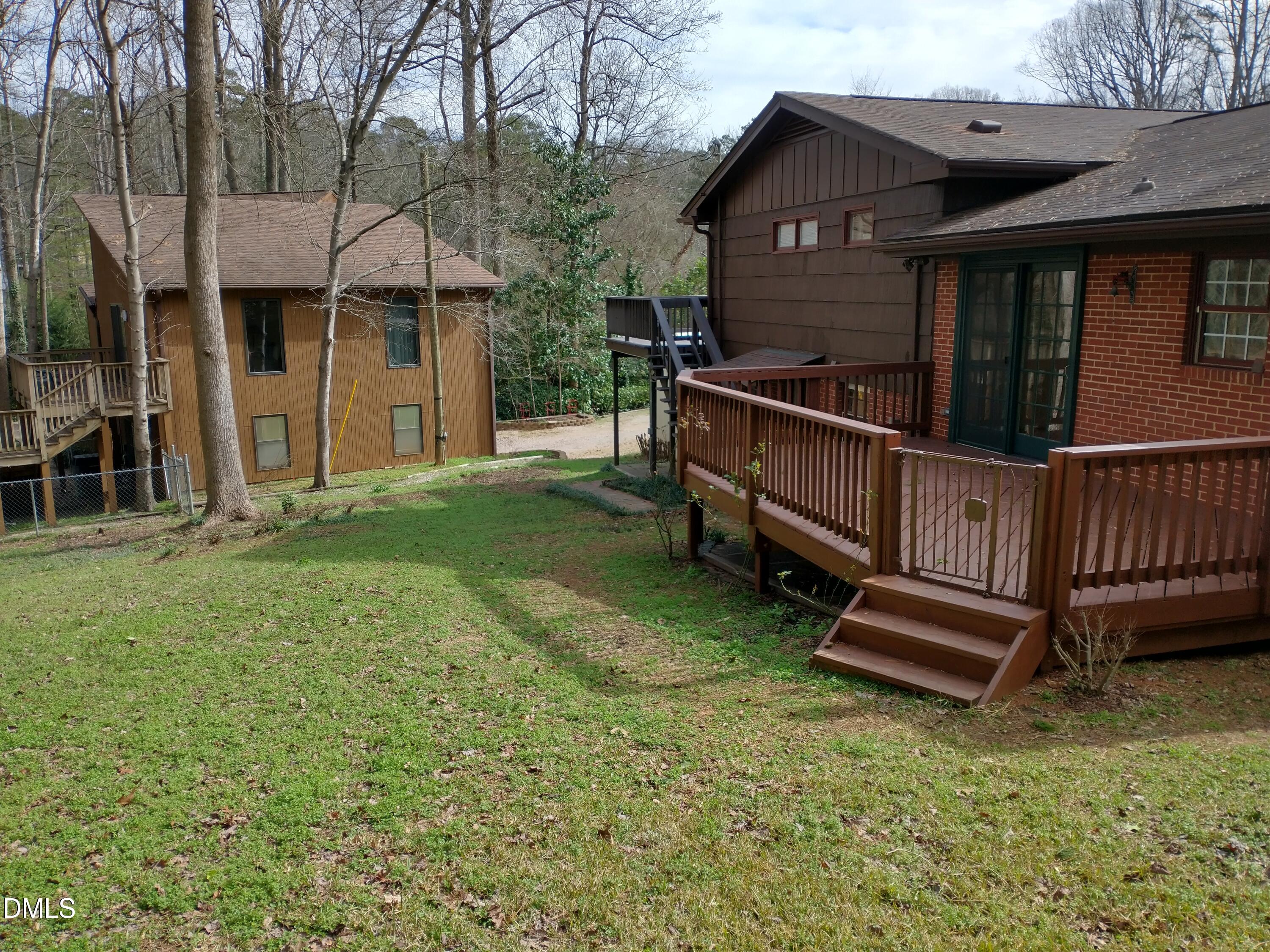 1302 Lorimer Road Raleigh, NC 27606 - Photo 21 of 23 a view of a house with a yard and wooden fence