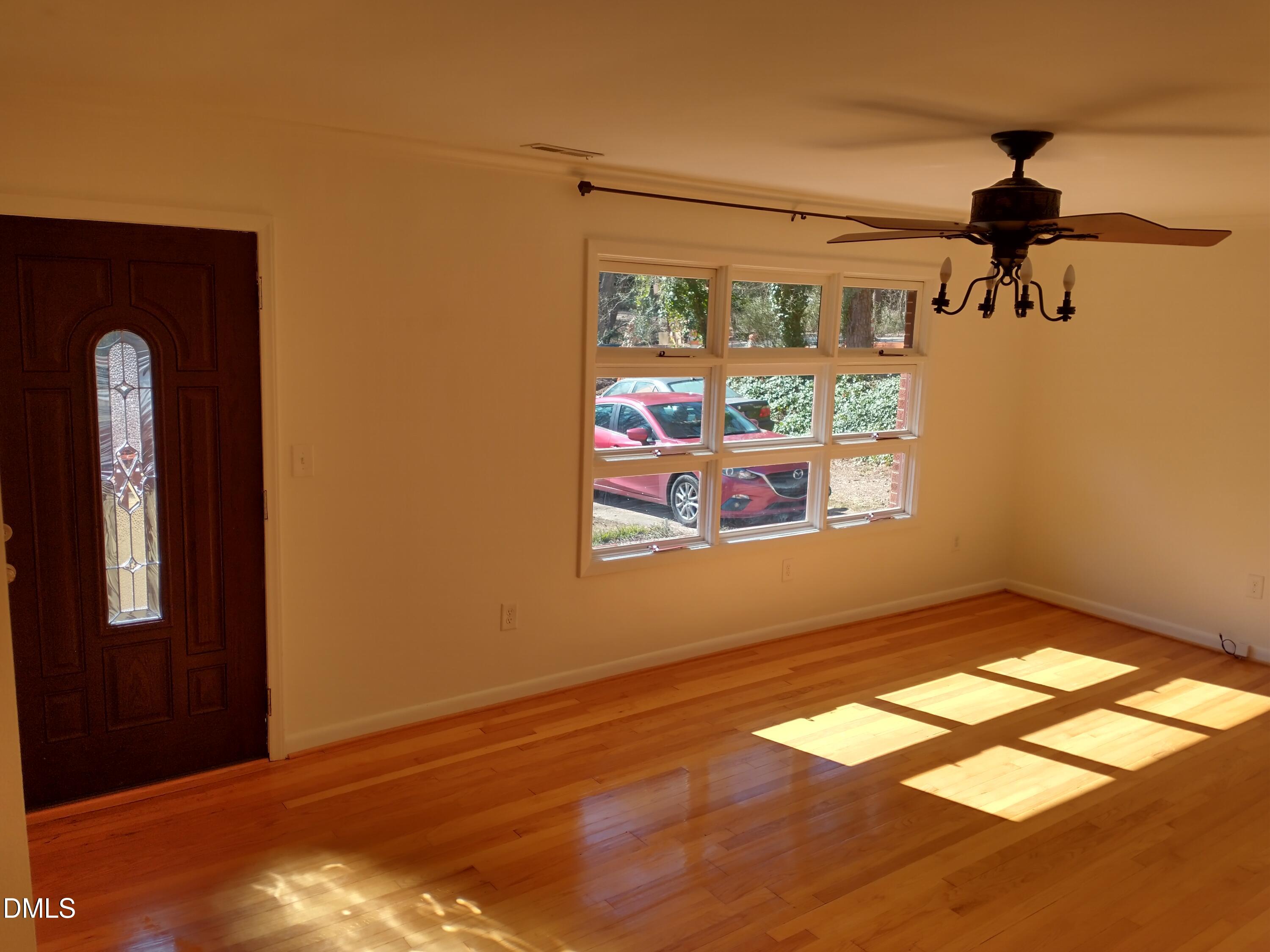 1302 Lorimer Road Raleigh, NC 27606 - Photo 3 of 23 a view of empty room with wooden floor and fan
