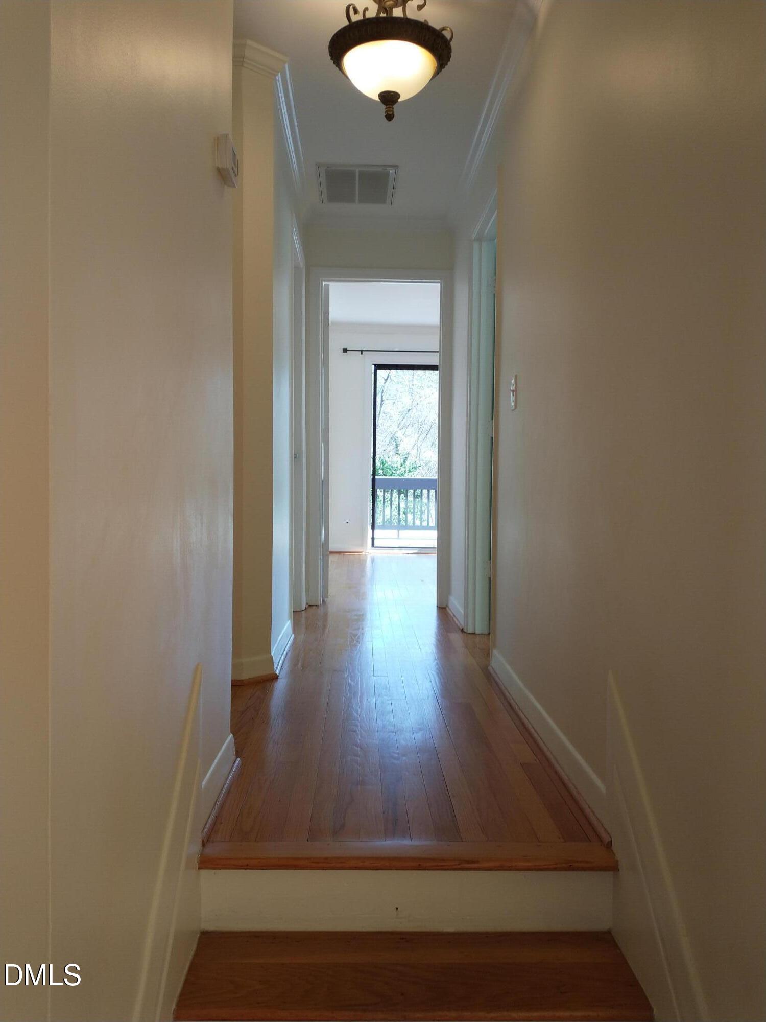 1302 Lorimer Road Raleigh, NC 27606 - Photo 8 of 23 a view of a hallway with wooden floor