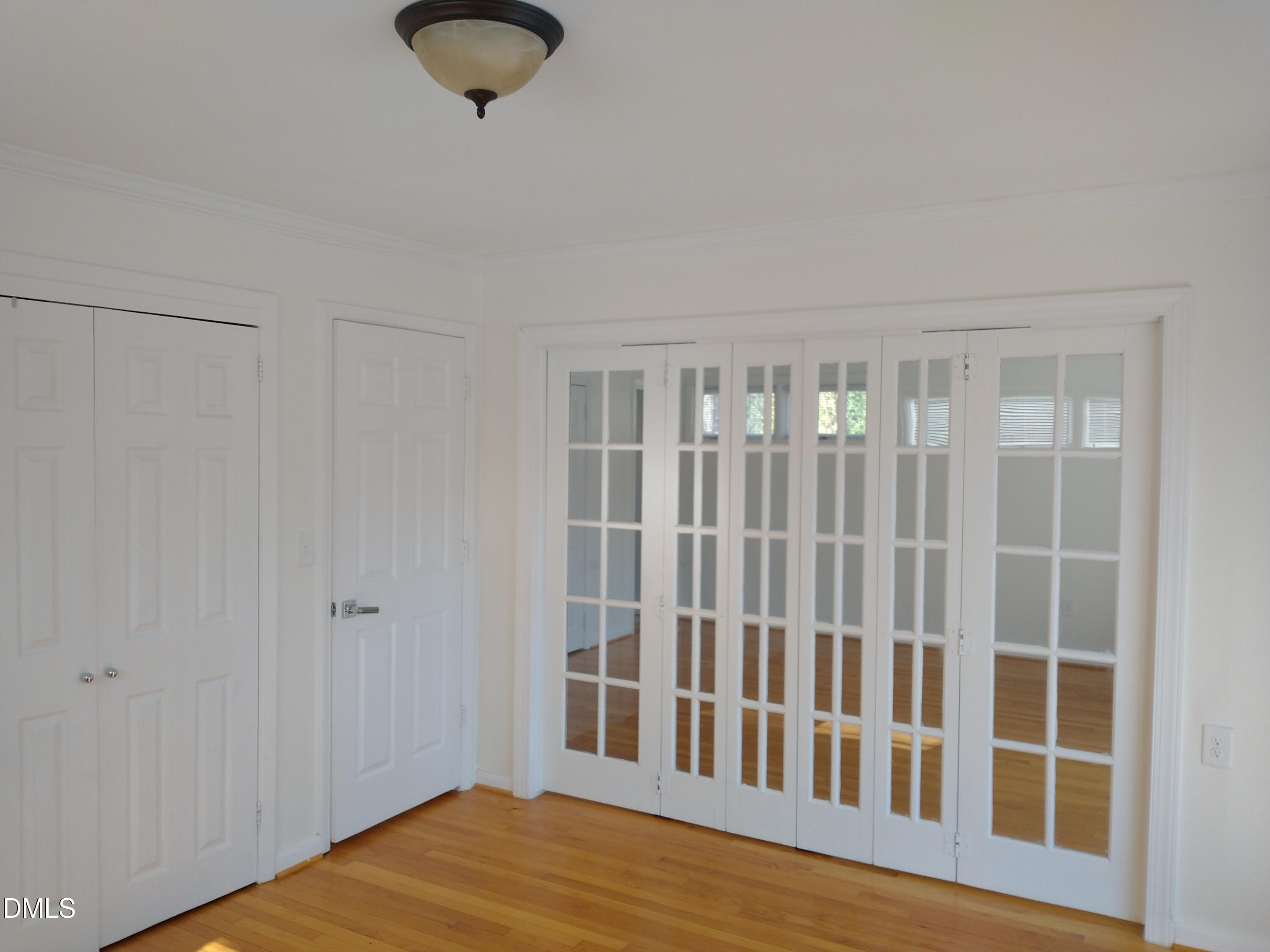 1302 Lorimer Road Raleigh, NC 27606 - Photo 9 of 23 a view of wooden floor and windows in a room
