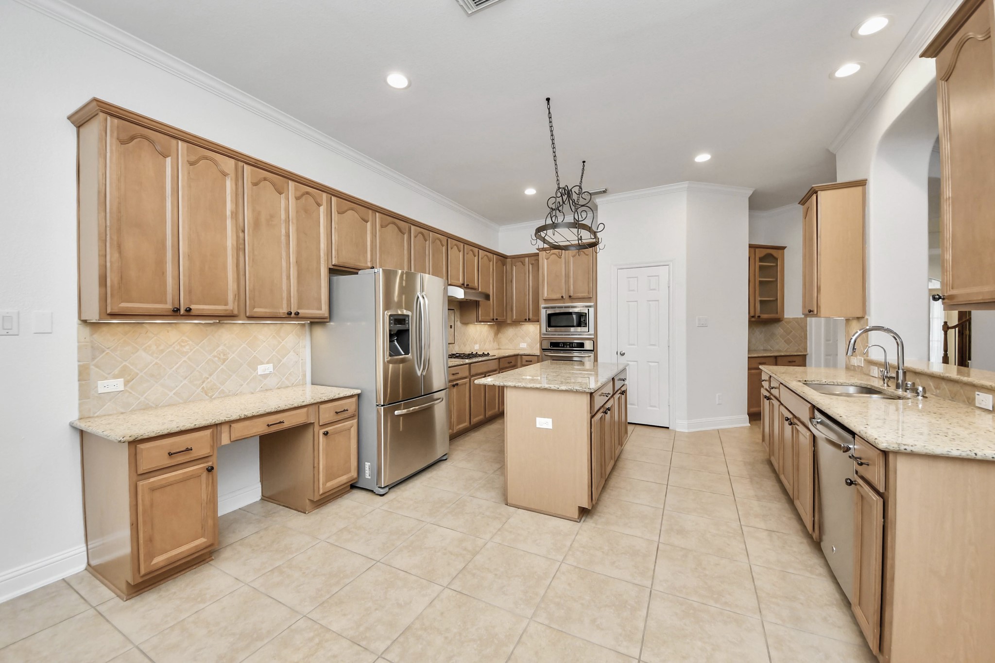20519 Rosespring Lane Spring, TX 77379 - Photo 13 of 49 a kitchen with stainless steel appliances granite countertop a refrigerator a sink dishwasher a stove with white cabinets