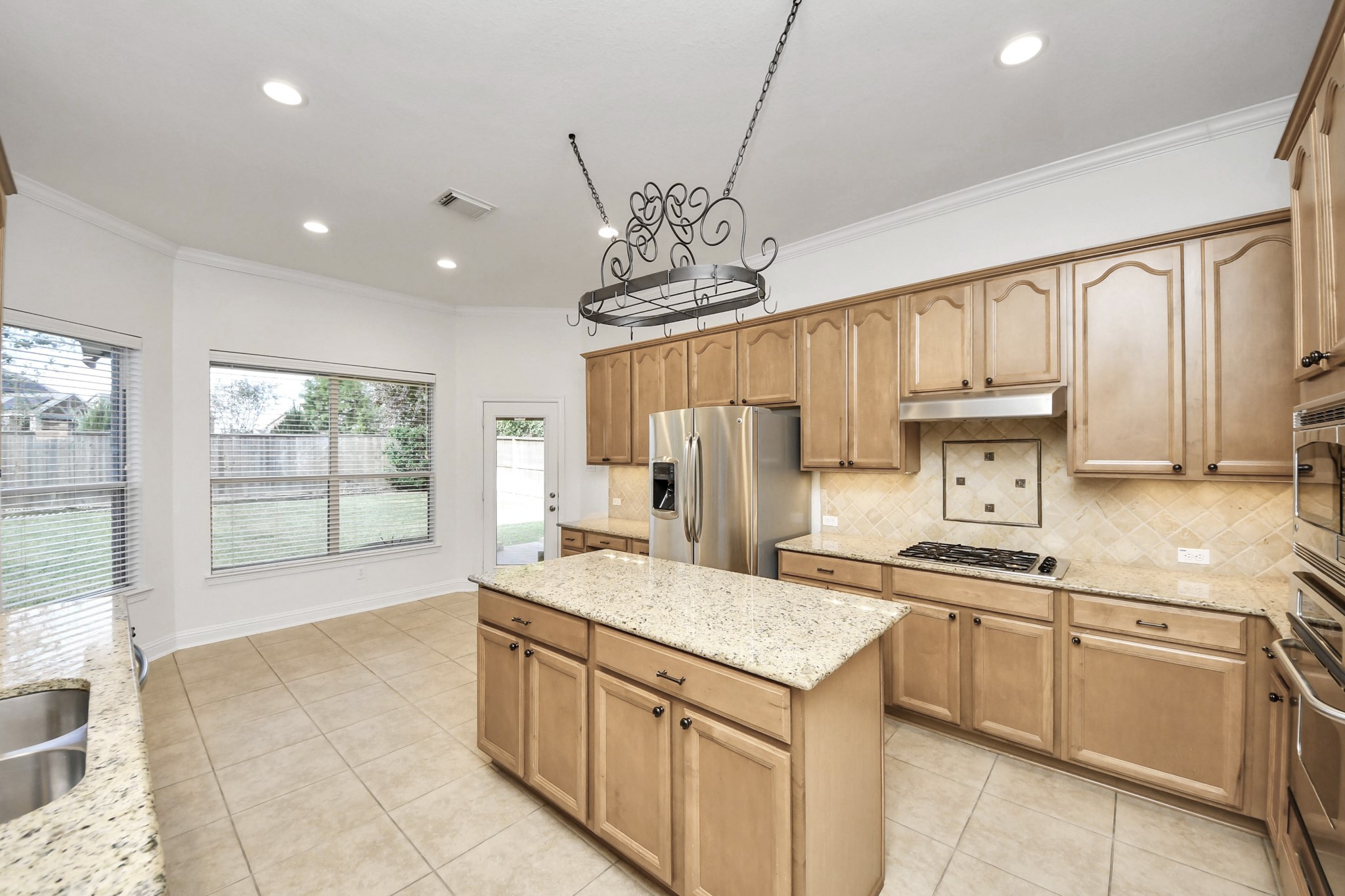 20519 Rosespring Lane Spring, TX 77379 - Photo 17 of 49 a kitchen with stainless steel appliances granite countertop a sink and cabinets