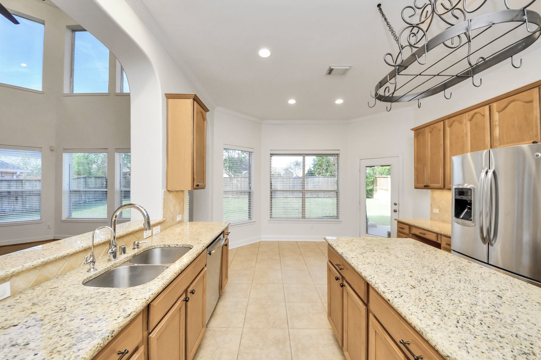 20519 Rosespring Lane Spring, TX 77379 - Photo 19 of 49 a large kitchen with kitchen island a large window a sink and stainless steel appliances