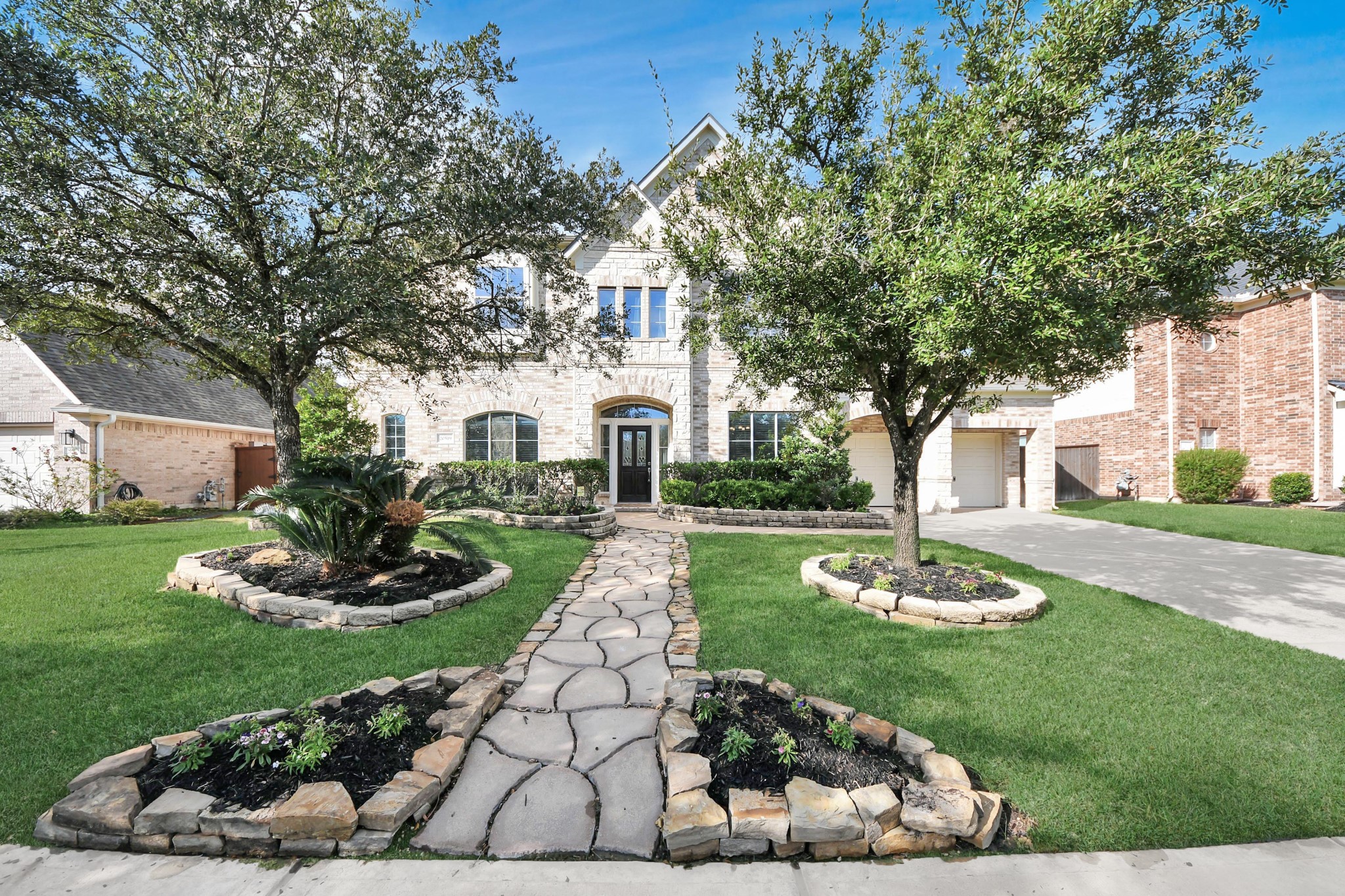 20519 Rosespring Lane Spring, TX 77379 - Photo 2 of 49 a front view of a house with a garden and yard