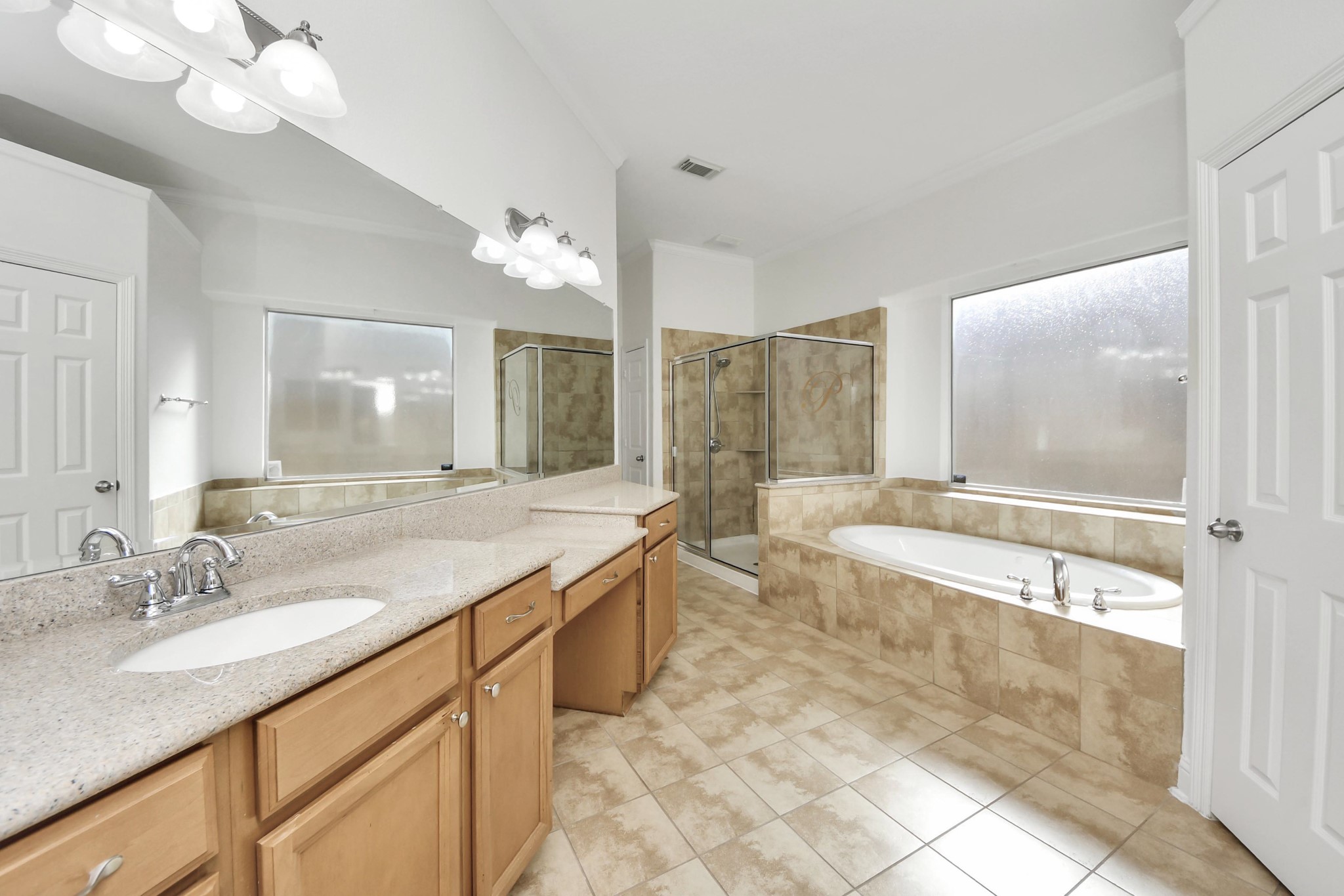 20519 Rosespring Lane Spring, TX 77379 - Photo 24 of 49 a bathroom with a granite countertop sink a large mirror and a bathtub