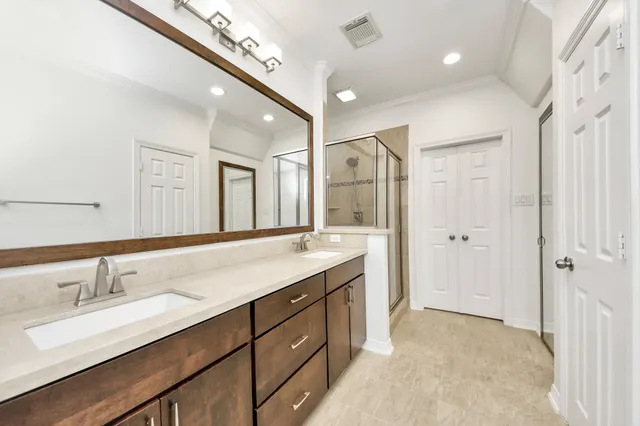 a spacious bathroom with a double vanity sink mirror and double