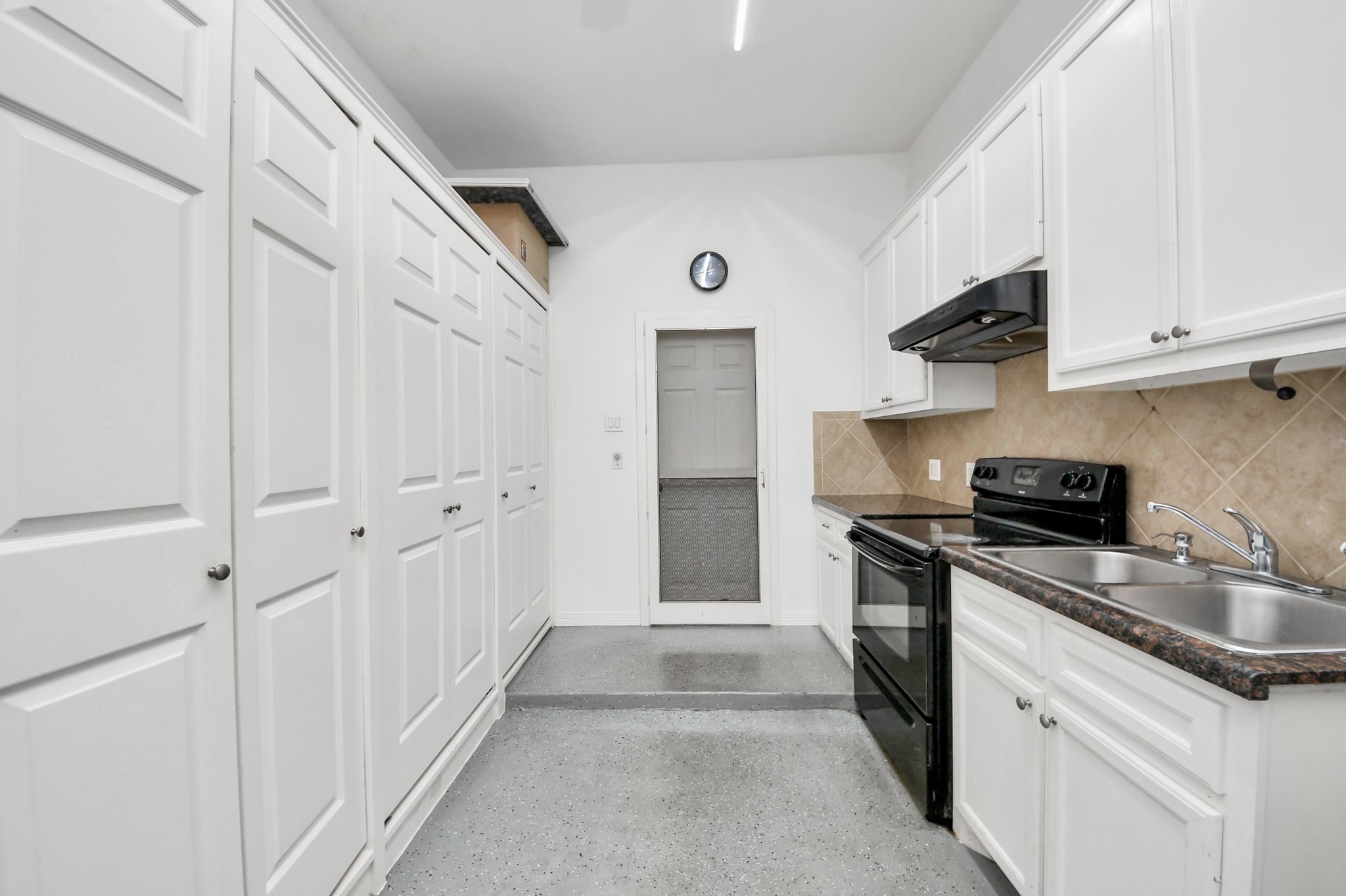 20519 Rosespring Lane Spring, TX 77379 - Photo 43 of 49 a kitchen with white cabinets and stainless steel appliances