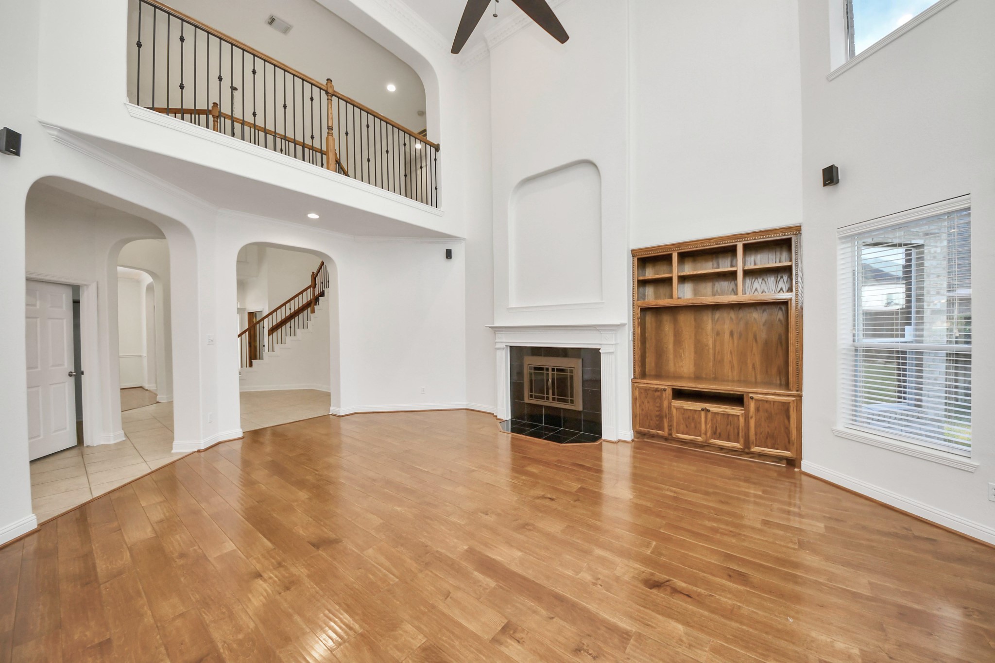 20519 Rosespring Lane Spring, TX 77379 - Photo 10 of 49 a view of an empty room with wooden floor fireplace and windows