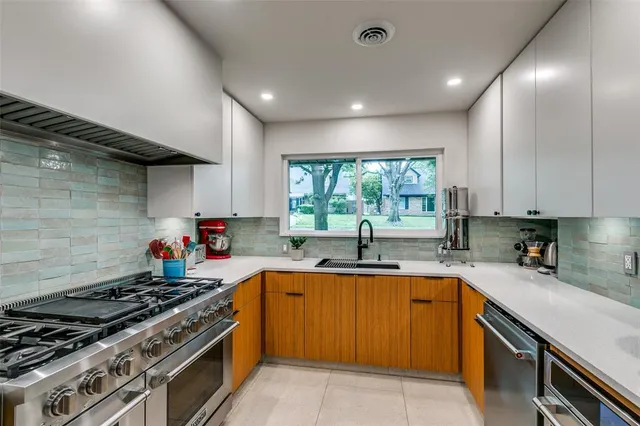 a kitchen with a sink stove top oven and cabinets