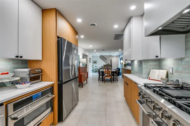 a kitchen with stainless steel appliances granite countertop a stove and a refrigerator