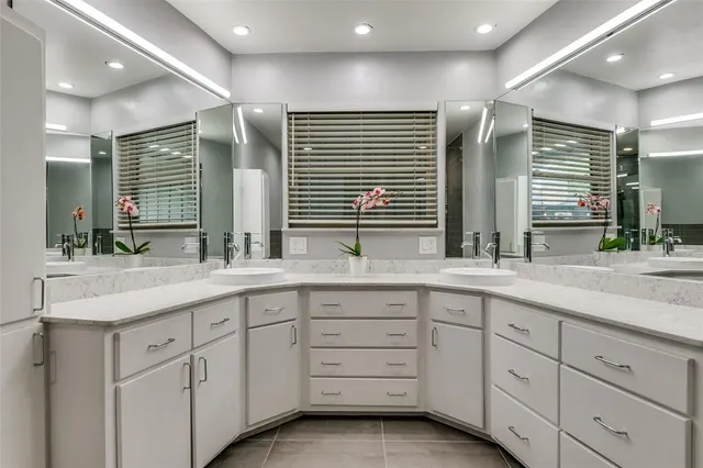 a bathroom with double sink and a large mirror