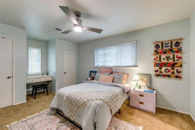a bedroom with a bed and a book shelf