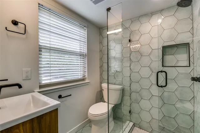 a bathroom with a toilet sink and shower