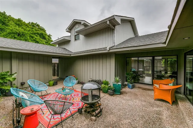 a backyard of a house with outdoor seating