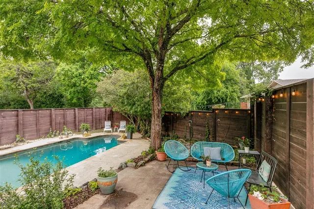 a view of a backyard with furniture and garden