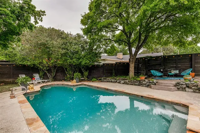 a view of a swimming pool with lounge chairs