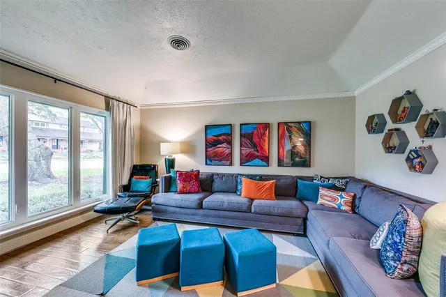 a living room with furniture and a floor to ceiling window