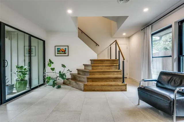a living room with furniture and stairs
