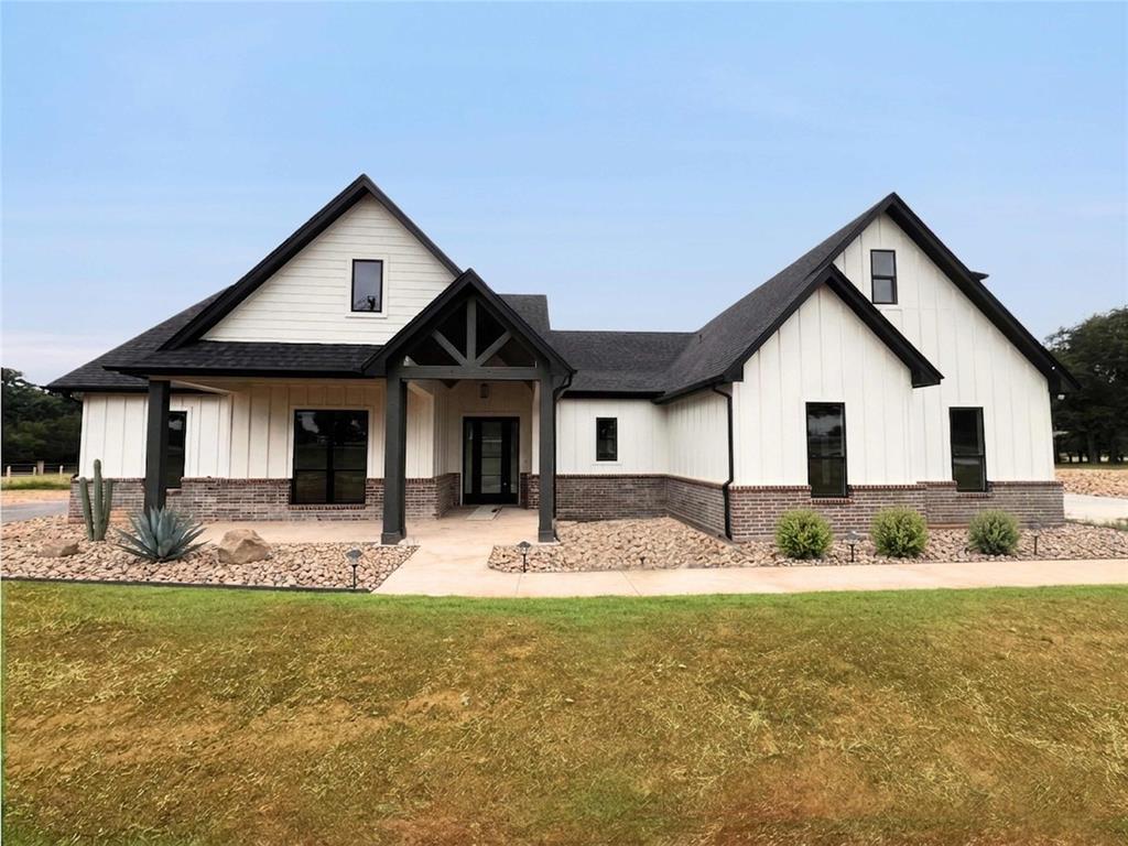 121 Cartwright Park Road Weatherford, TX 76087 - Photo 1 of 17 Modern farmhouse exterior featuring white vertical siding and dark brick accents