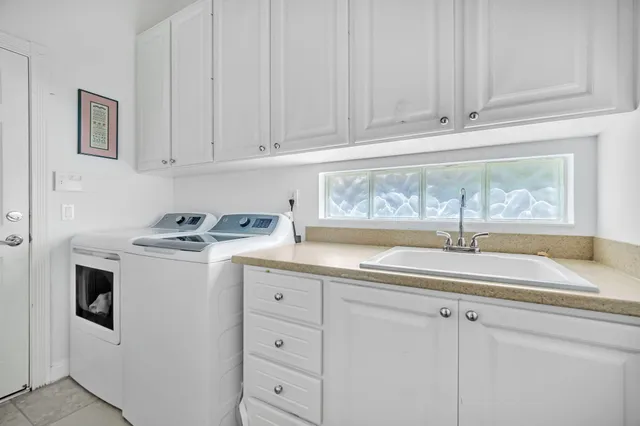a kitchen with granite countertop a sink and a stove