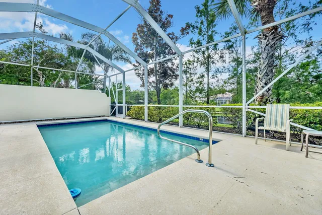 a view of a swimming pool with a patio and couches