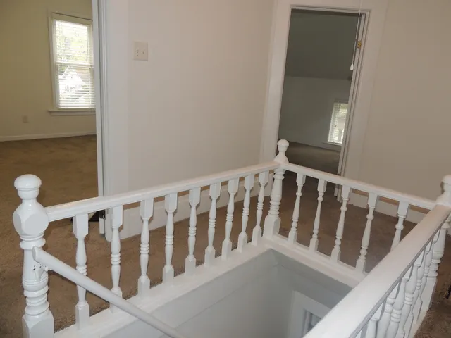 a view of wooden floor and small racks in a balcony