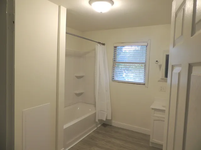 a bathroom with a bathtub and shower