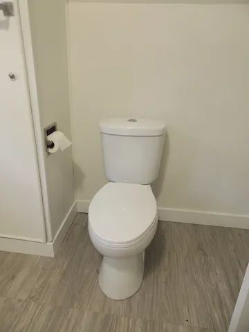 a white toilet sitting next to a bathroom sink