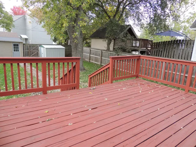 a balcony with wooden floor and outdoor space